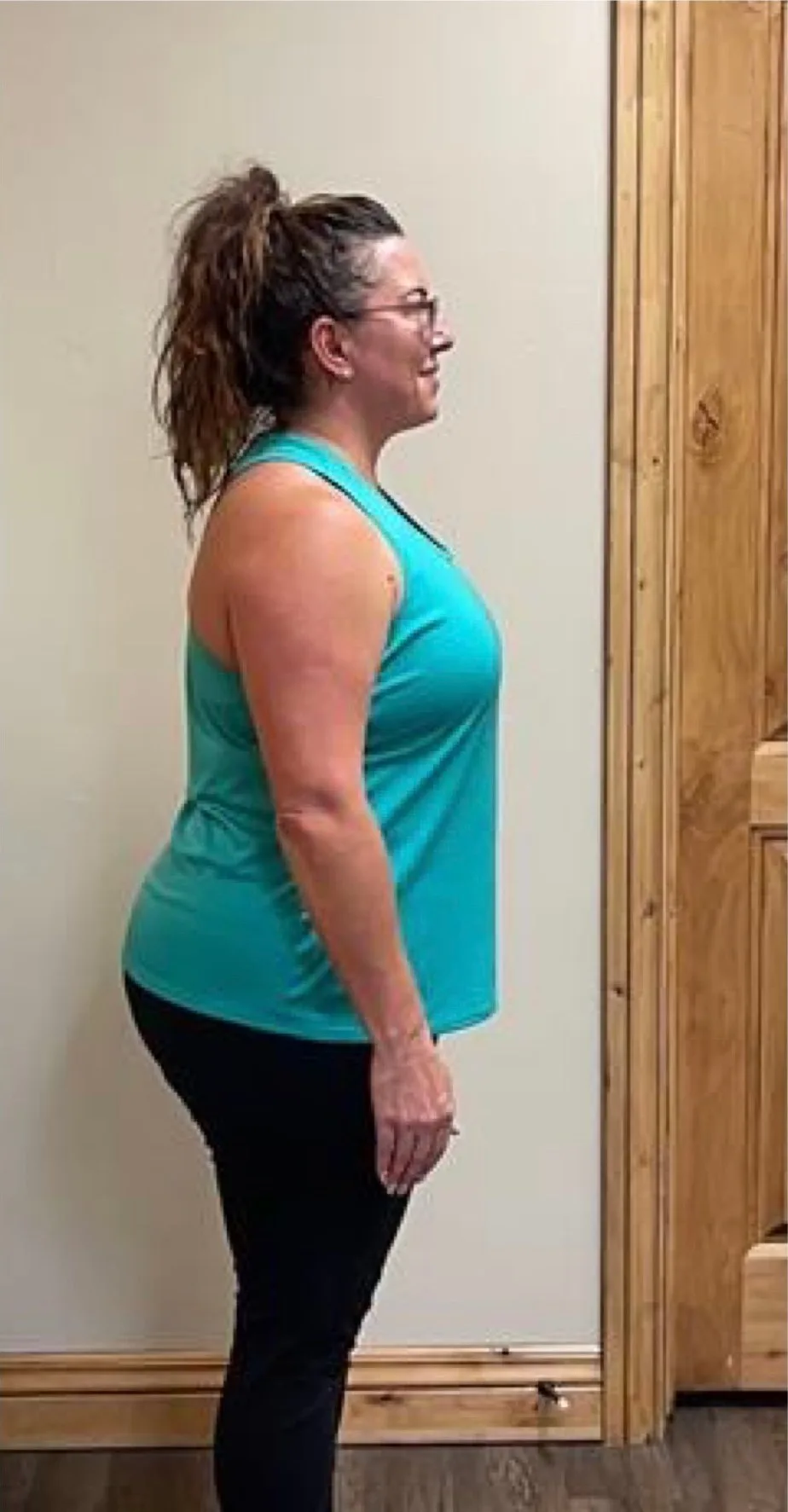 The same client photographed from the side after coaching with Nathan Brennan, visibly leaner and more upright