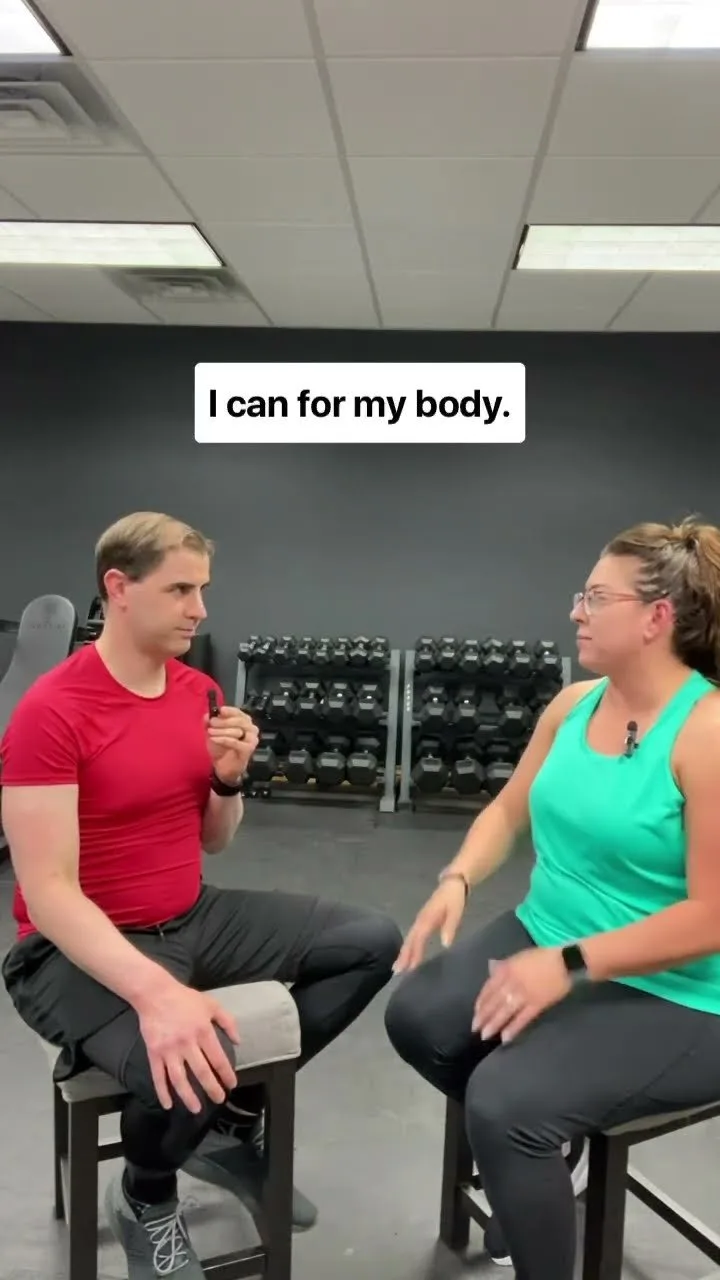 Jess sitting with Nathan Brennan in the gym during her testimonial interview